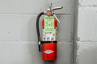An Abc Fire Extinguisher Hanging On A Wall Jpg